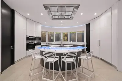 a kitchen with a table and stools in it at Chantilly Lace in Los Angeles