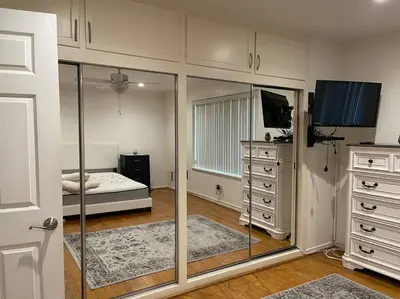 a bedroom with a bed and a dresser and a mirror at Luxury Oasis Home w/Pool Near CSUN-6 Guests in North Hills