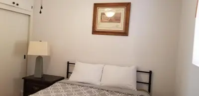a bedroom with a bed and a picture on the wall at Panoramic Lake View, Lake Isabella in Wofford Heights