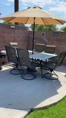 a table and chairs under an umbrella on a patio at Vacation Rental w Pool &Garden 6 Guests near CSUN in North Hills