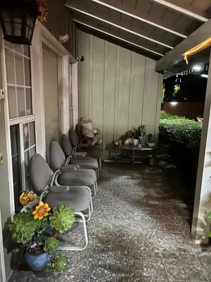 a row of chairs sitting on a patio at Vacation Rental w Pool &Garden 6 Guests near CSUN in North Hills