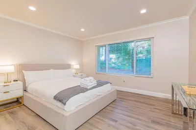 a white bedroom with a bed and a window at Single Level House with view and pool in Glendora