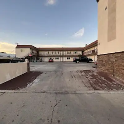 an empty parking lot in front of a building at Stay Inn Motel in Harbor City