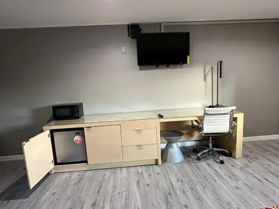 an office with a desk with a television on the wall at Stay Inn Motel in Harbor City