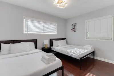 a bedroom with two beds and a window at 5 Bedroom Charmer with Pool in Reseda
