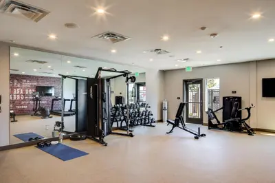 a gym with treadmills and machines in a room at Ayres Hotel Rialto Fontana in Rialto