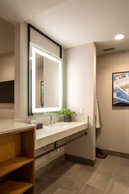 a bathroom with a sink and a mirror at Ayres Hotel Rialto Fontana in Rialto