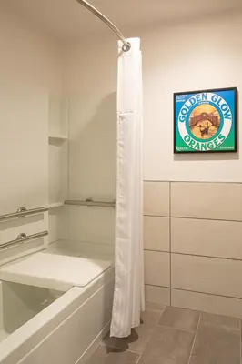 a bathroom with a tub and a sign on the wall at Ayres Hotel Rialto Fontana in Rialto