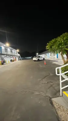 a car parked in a parking lot at night at Plaza Inn Motel - Los Angeles area in Rosemead