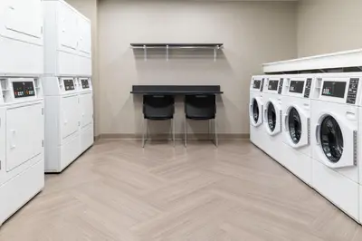 a laundry room with a counter and washing machines at Residence Inn by Marriott Anaheim Brea in Brea
