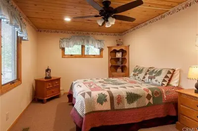 a bedroom with a bed and a ceiling fan at Narrow Escape - Close to Lake and Slopes in Big Bear Lake