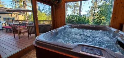 a jacuzzi tub in the middle of a porch at Narrow Escape - Close to Lake and Slopes in Big Bear Lake