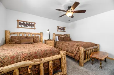 a bedroom with two beds and a ceiling fan at A Snowmass Haven - EV, Sauna, Hot Tub - Walk to Slopes/lake in Big Bear Lake