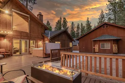 a deck with a fire pit on a house at A Snowmass Haven - EV, Sauna, Hot Tub - Walk to Slopes/lake in Big Bear Lake