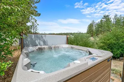 a hot tub in a backyard with at Lakefront the Cove - On the Lake in Big Bear Lake