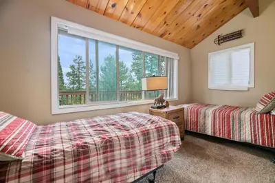 a bedroom with two beds and a window at Lakeview Trout N About - Walk to Lake, Close to Village & Slopes in Big Bear Lake