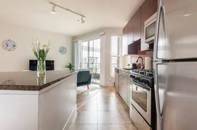a kitchen with a stainless steel refrigerator and a counter at Tulum Vibes 1 Bedroom Apartment near Boats in Marina Del Rey in Los Angeles