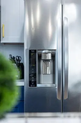 a silver refrigerator with a coffee pot in it at Luxury Villa with Hot Tub! Minutes to Beach & Bars in Long Beach