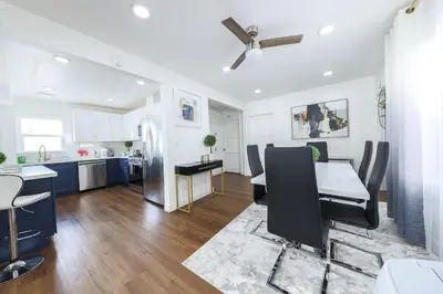 a kitchen and living room with a table and chairs at Luxury Villa with Hot Tub! Minutes to Beach & Bars in Long Beach