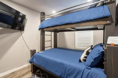 a bedroom with two bunk beds and a flat screen tv at Fam Friendly 2BD 8min from airport, 4min from SoFi in Los Angeles