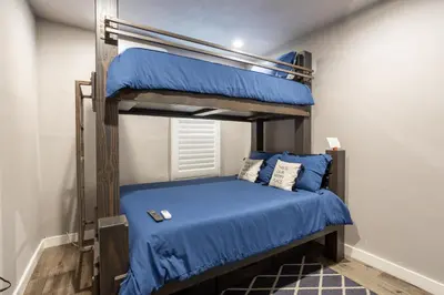 a bedroom with two bunk beds with blue sheets at Fam Friendly 2BD 8min from airport, 4min from SoFi in Los Angeles