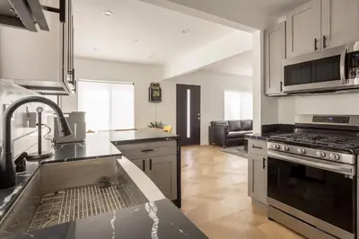 a kitchen with a sink and a stove top oven at Coziest 1BD Bungalow 8min from airport, 4 min SoFi in Los Angeles