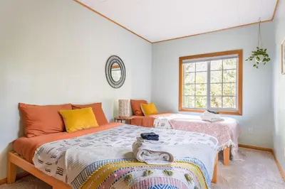 a bedroom with two beds and a window at Aery Pines in Wrightwood