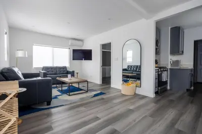 a living room with a couch and a table at Bungalow w Free Parking 4 min from SoFi, 8min from airport in Los Angeles