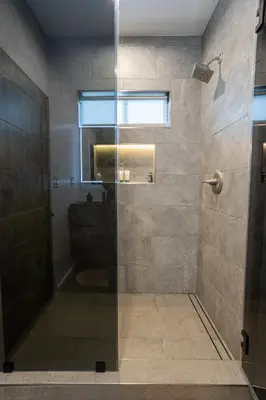 a bathroom with a shower with a glass door at Bungalow w Free Parking 4 min from SoFi, 8min from airport in Los Angeles
