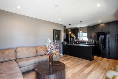 a living room with a couch and a table at Newly Renovated Bungalow w Free Parking 4min from SoFi, 8min from Airport in Los Angeles