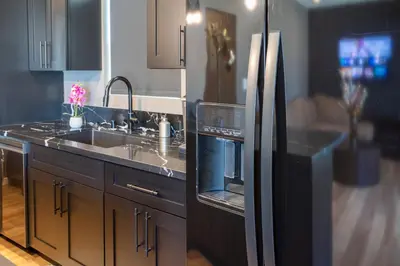 a kitchen with a sink and a refrigerator at Newly Renovated Bungalow w Free Parking 4min from SoFi, 8min from Airport in Los Angeles