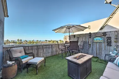 a patio with a table and chairs and an umbrella at Walk to Ventura Beach Comfy Home with Ocean Views in Ventura