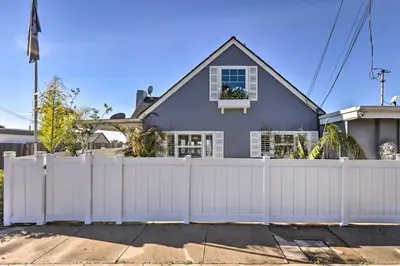 a white fence in front of a house at Walk to Ventura Beach Comfy Home with Ocean Views in Ventura