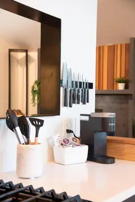 a kitchen counter with utensils on a counter top at Modern Treetop Cabin by Lake Arrowhead Village in Lake Arrowhead