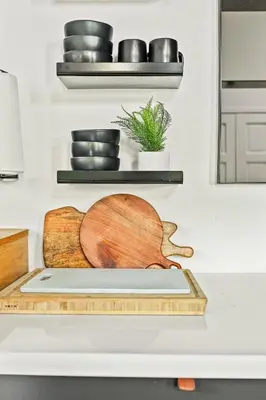 aplate of bowls and plates on a shelf in a kitchen at Modern Treetop Cabin by Lake Arrowhead Village in Lake Arrowhead