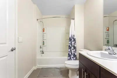 a white bathroom with a sink and a toilet at Luxury 2 Bedroom 2 Bathroom With Fitness Center and Pool in Los Angeles