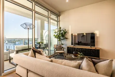 a living room with a couch and a tv at @ Marbella Lane - Luxury Beachside 2BR in Long Beach