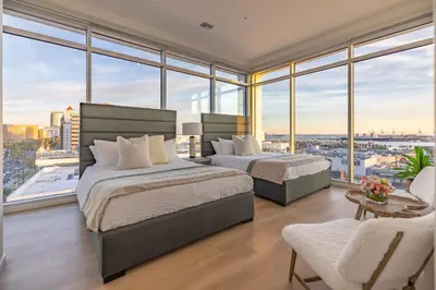 two beds in a bedroom with a view of the city at @ Marbella Lane - Luxury Beachside 2BR in Long Beach