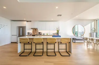a kitchen with a island with bar stools at @ Marbella Lane - Luxurious 3BR Penthouse in Long Beach