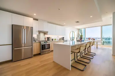 a kitchen with white cabinets and stainless steel appliances at @ Marbella Lane - Luxurious 3BR Penthouse in Long Beach