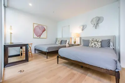 a bedroom with a bed and a table and a desk at @ Marbella Lane - Luxurious 3BR Penthouse in Long Beach