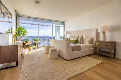 a living room with a couch and a large window at @ Marbella Lane - Penthouse w/ City & Ocean Views in Long Beach