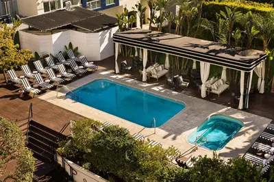 an overhead view of a swimming pool with chairs and a house at The Eden in Los Angeles