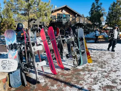a bunch of snowboards are lined up on a rack at Sled-Ski Snow Summit Lakeside Village - Spa - BBQ - Firepit - Loft - Games in Big Bear Lake