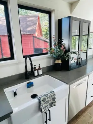a kitchen with a white sink and two windows at Sled-Ski Snow Summit Lakeside Village - Spa - BBQ - Firepit - Loft - Games in Big Bear Lake