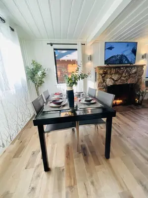a dining room with a table and a fireplace at Sled-Ski Snow Summit Lakeside Village - Spa - BBQ - Firepit - Loft - Games in Big Bear Lake