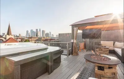 a rooftop deck with a tub and a fire pit at Gorgeous DTLA w/ View + Hot Tub! in Los Angeles