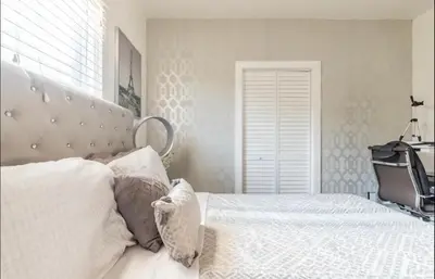 a bedroom with a white bed with a large headboard at Gorgeous DTLA w/ View + Hot Tub! in Los Angeles