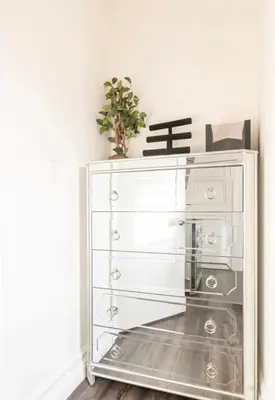 a white chest of drawers with a plant on top at Gorgeous DTLA w/ View + Hot Tub! in Los Angeles