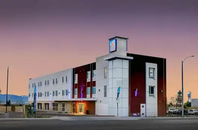 a building with a clock tower on top of it at Motel 6 Highland CA San Bernardino East in Highland